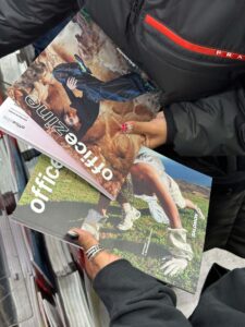 Attendees reading the Office Zine and Salomon print collaboration at the Mulberry Street launch