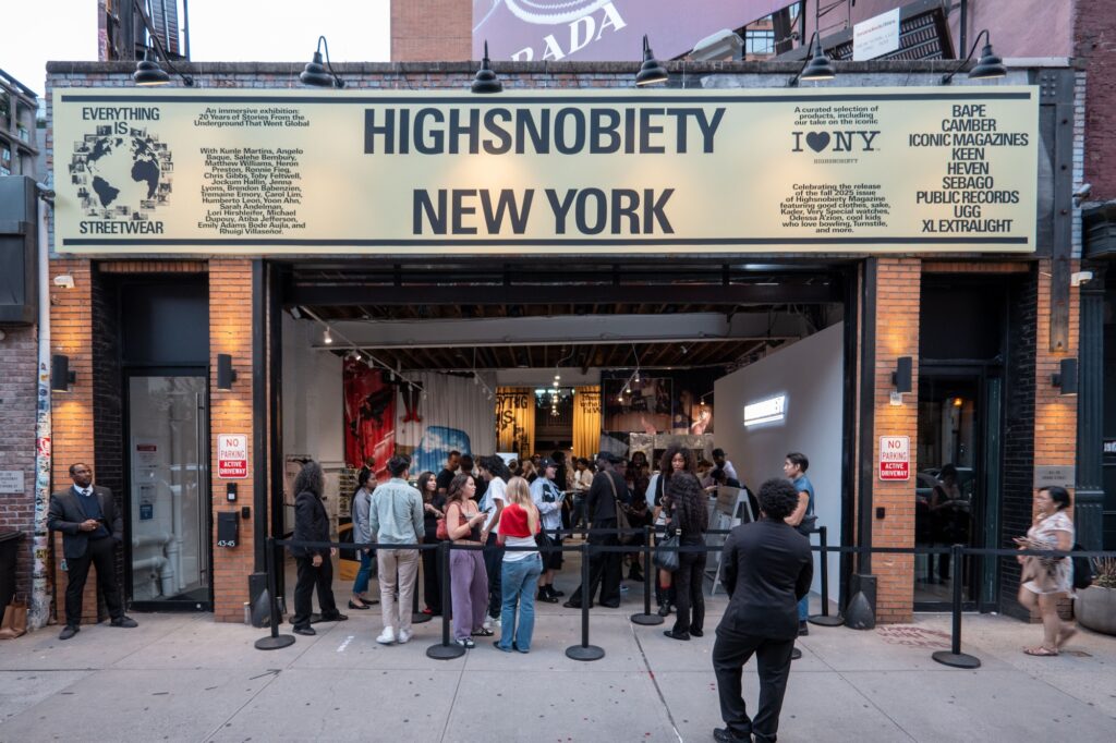 Iconic Magazines owner Hemal Sheth and an attendee holding an I LOVE NY and Highsnobiety poster.