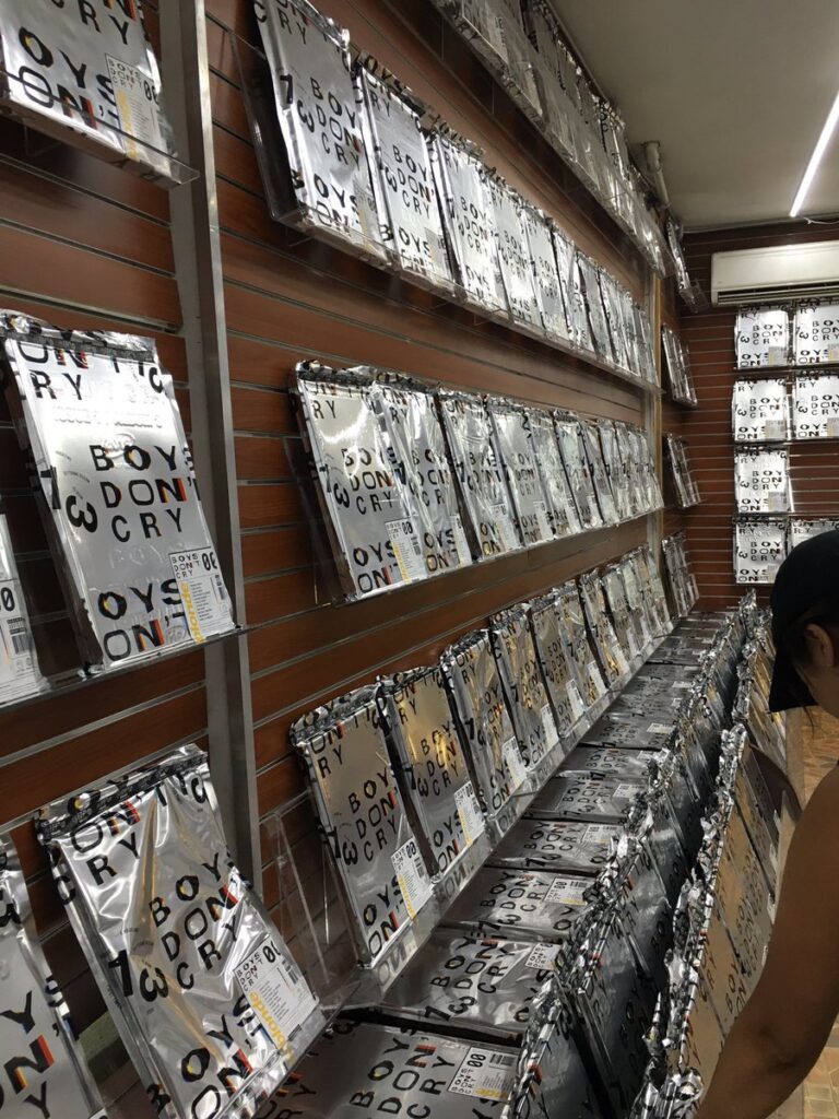 Foil-wrapped copies of Frank Ocean’s Boys Don’t Cry magazine covering the shelves inside the shop.