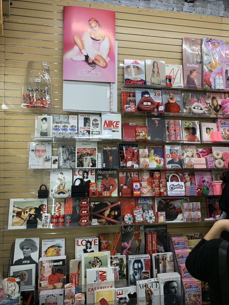red products wall for gelareh mizrahi's store takeover event at iconic magazines