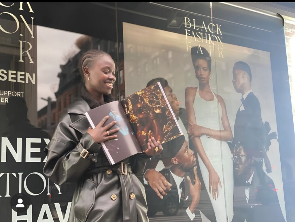 Talent featured in Black Fashion Fair Volume 0: SEEN holding the publication outside Iconic Magazines, Mulberry Street.