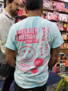 back of t-shirt that says gelareh mixrahi mini mart NYFW with smiley face