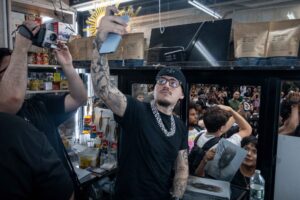 Yeat at the café window as fans film the Grailed zine drop at Iconic Magazines, Mulberry Street