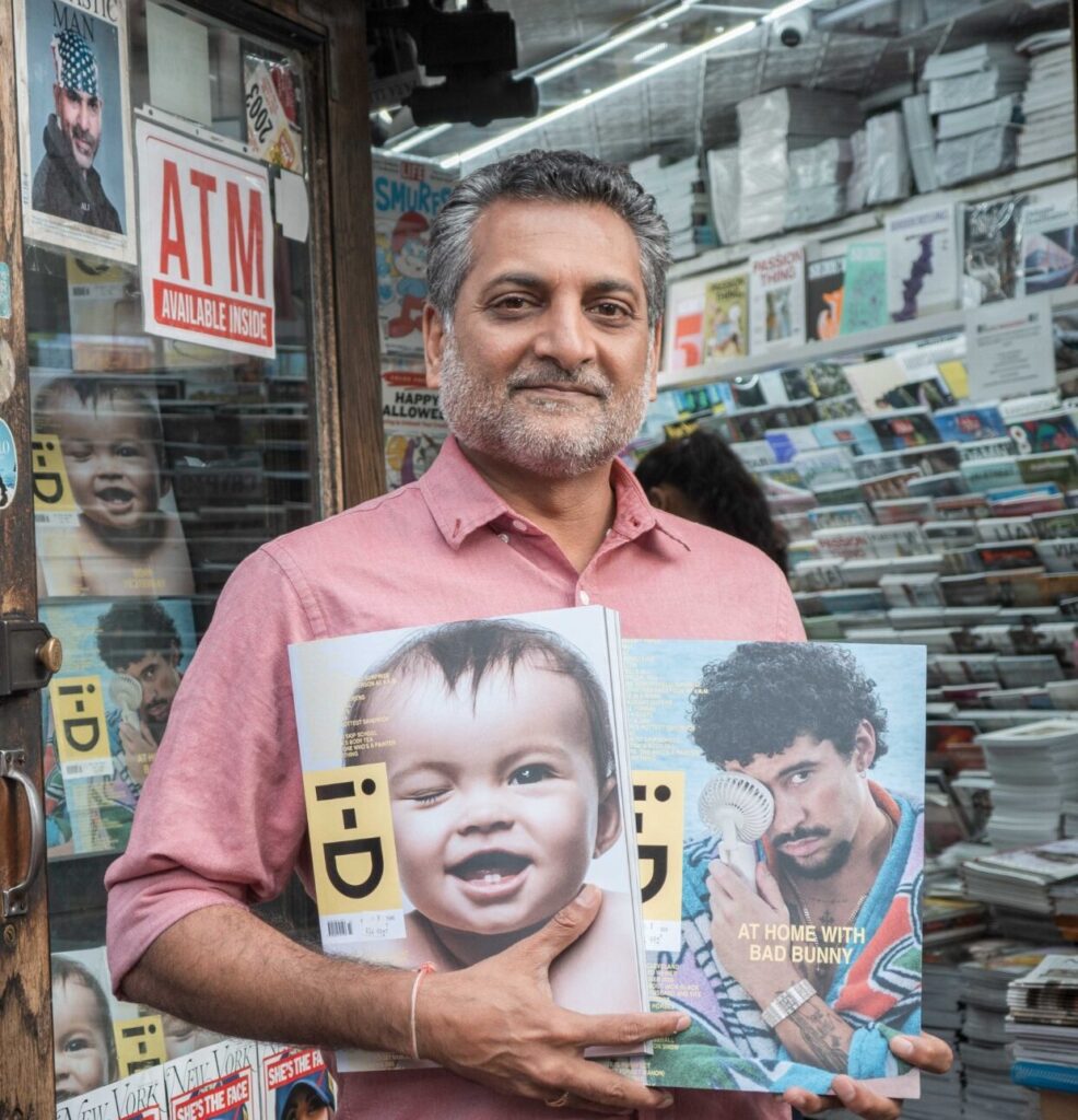 owner of iconic magazines hemal sheth in front of store with magazines in hand